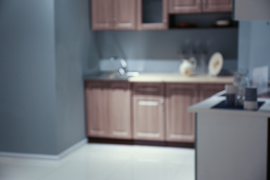 Blurred view of kitchen interior with modern furniture