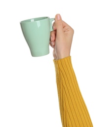 Woman holding elegant green cup on white background, closeup