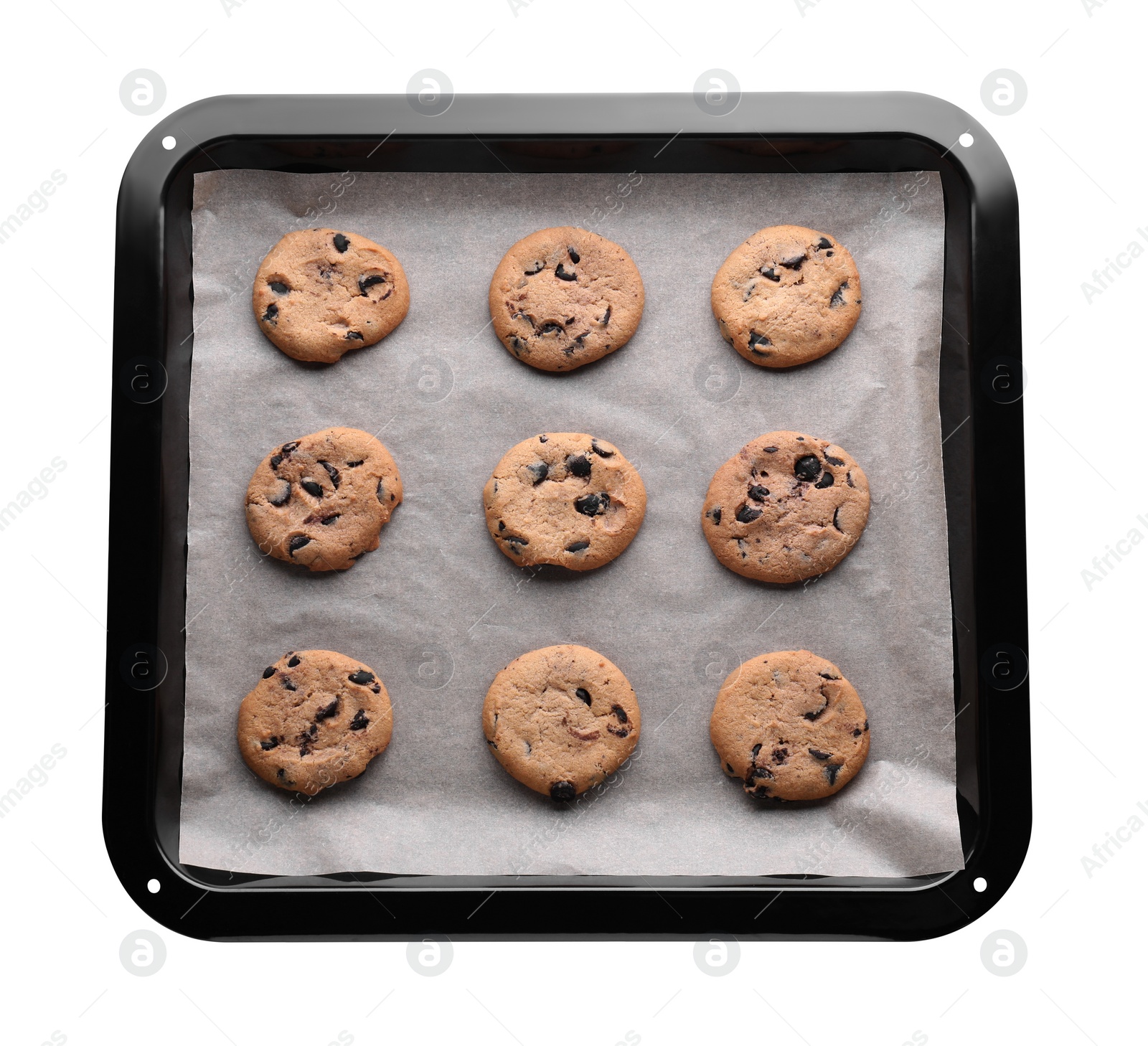 Photo of Baking pan with parchment paper and tasty cookies isolated on white, top view