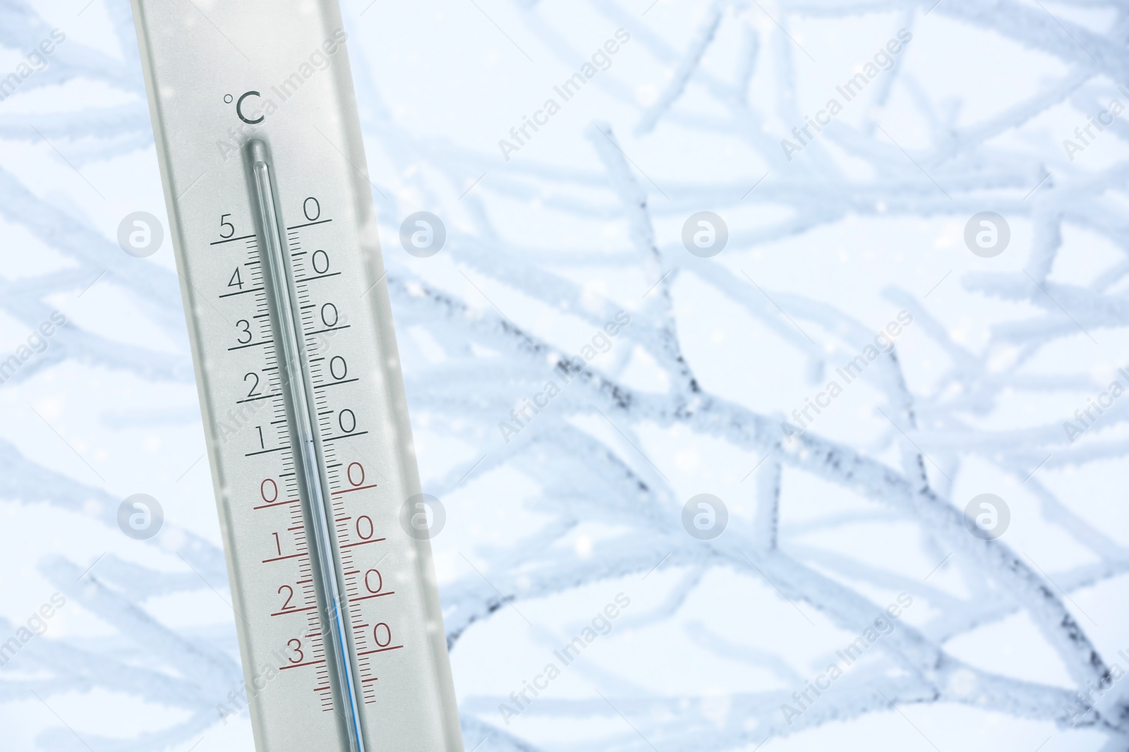 Image of Thermometer showing temperature below zero outdoors on winter day