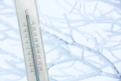 Image of Thermometer showing temperature below zero outdoors on winter day