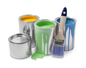 Photo of Cans of colorful paints and brush isolated on white