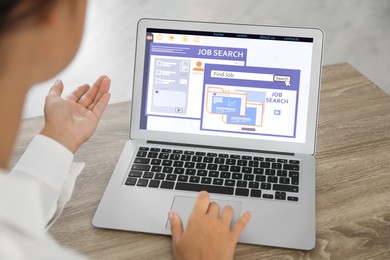 Image of Woman working with modern laptop at wooden table indoors, closeup. Job search