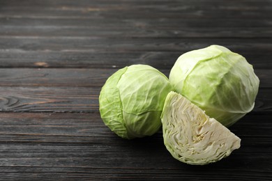 Photo of Ripe white cabbage on black wooden table