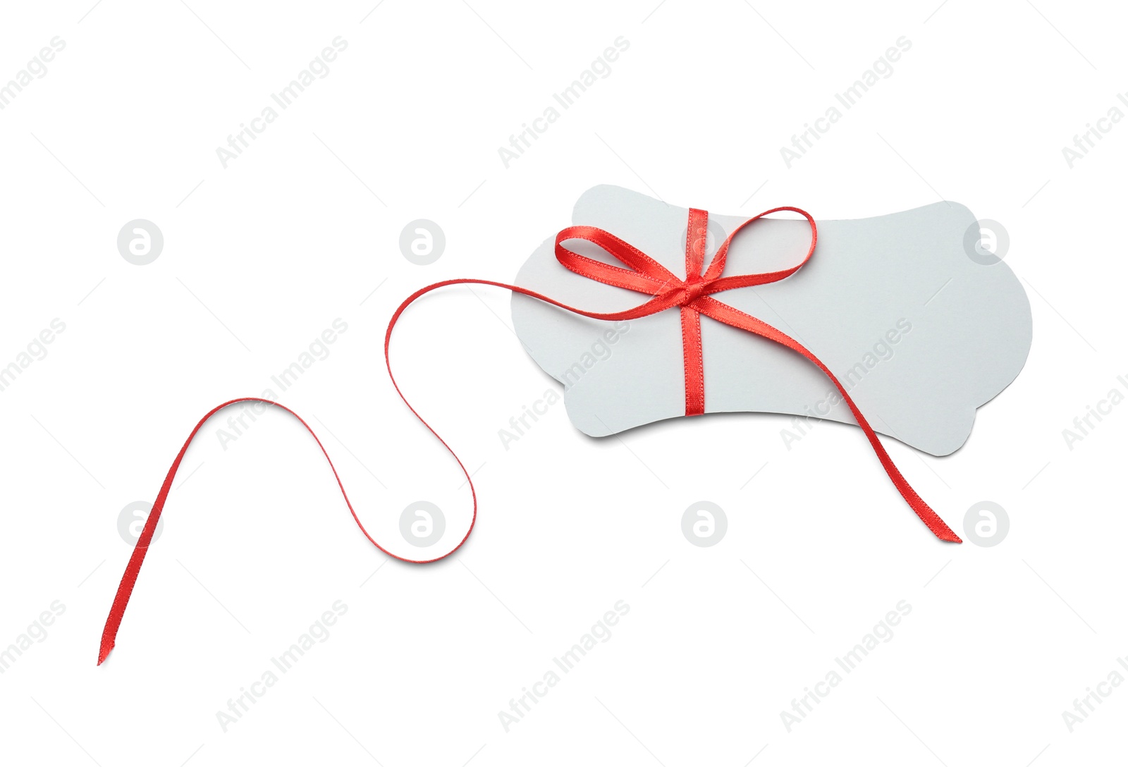 Photo of Blank gift tag with satin ribbon on white background, top view