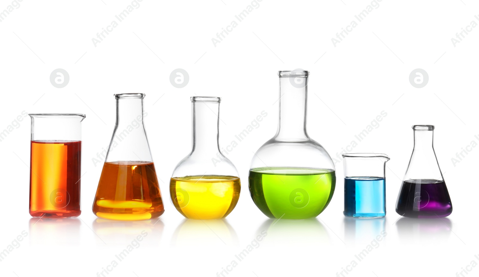 Photo of Laboratory glassware with color liquids on white background