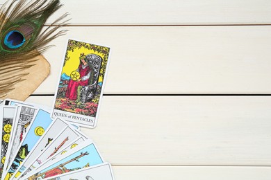 Photo of Flat lay composition with Queen of Pentacles and other tarot cards on white wooden table. Space for text