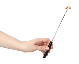 Tasty fondue. Woman holding fork with walnut and melted cheese on white background, closeup