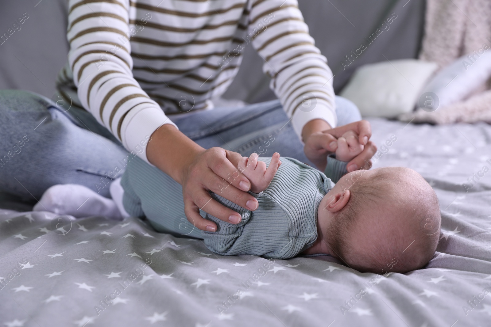 Photo of Mother and her little baby on bed, closeup