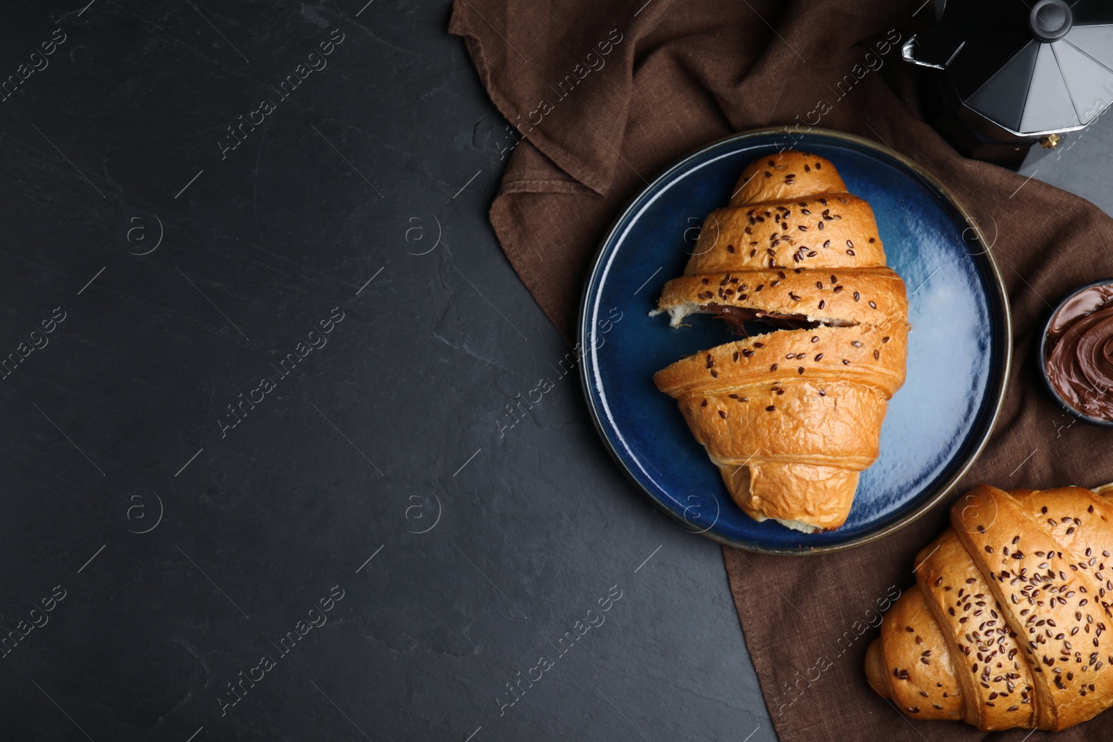 Photo of Flat lay composition with tasty croissants on black table. Space for text