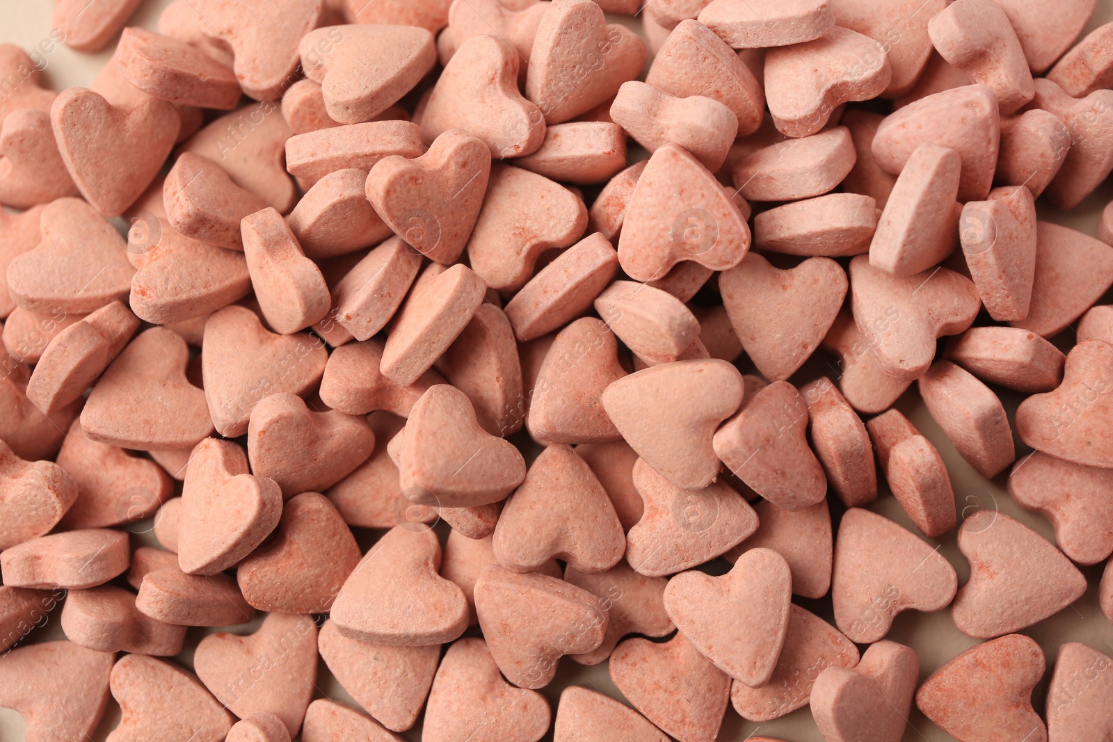 Photo of Heart shaped vitamins for pets as background, top view