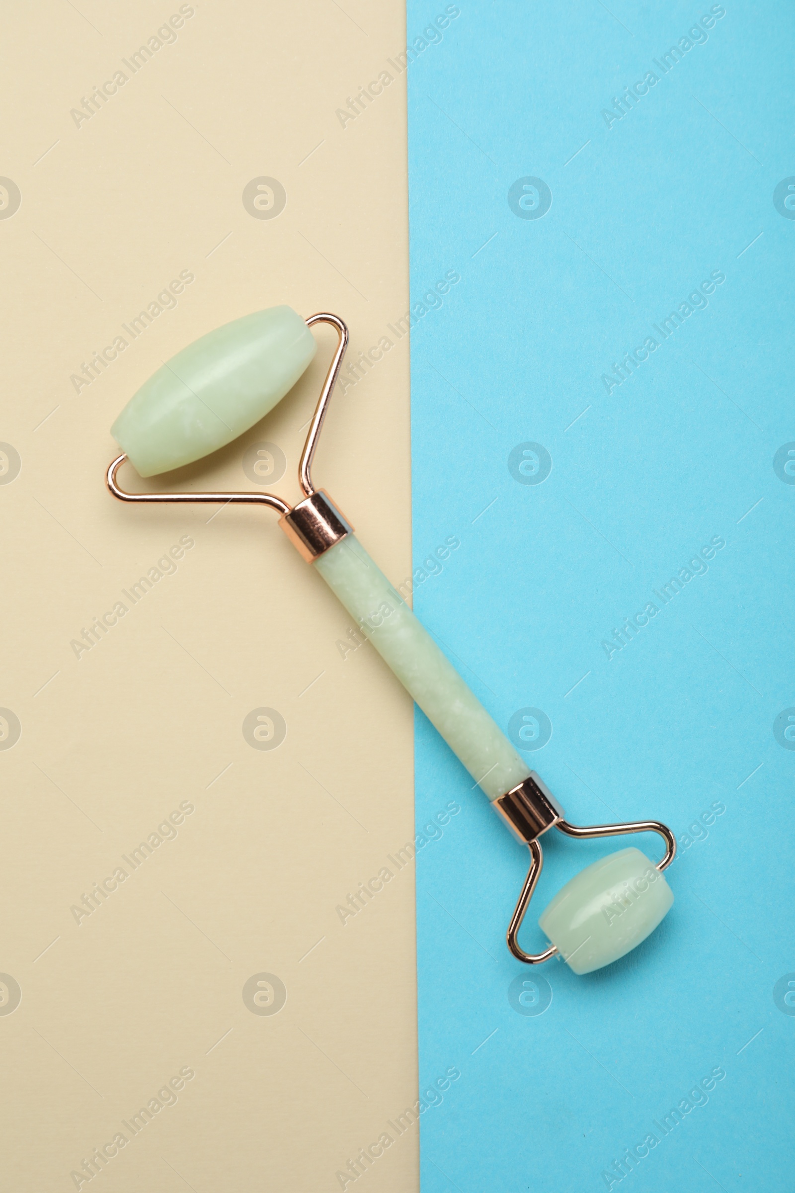 Photo of Natural face roller on color background, top view