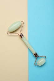 Photo of Natural face roller on color background, top view