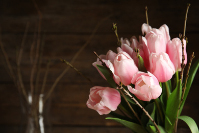 Photo of Beautiful bouquet of spring pink tulips on blurred background. Space for text