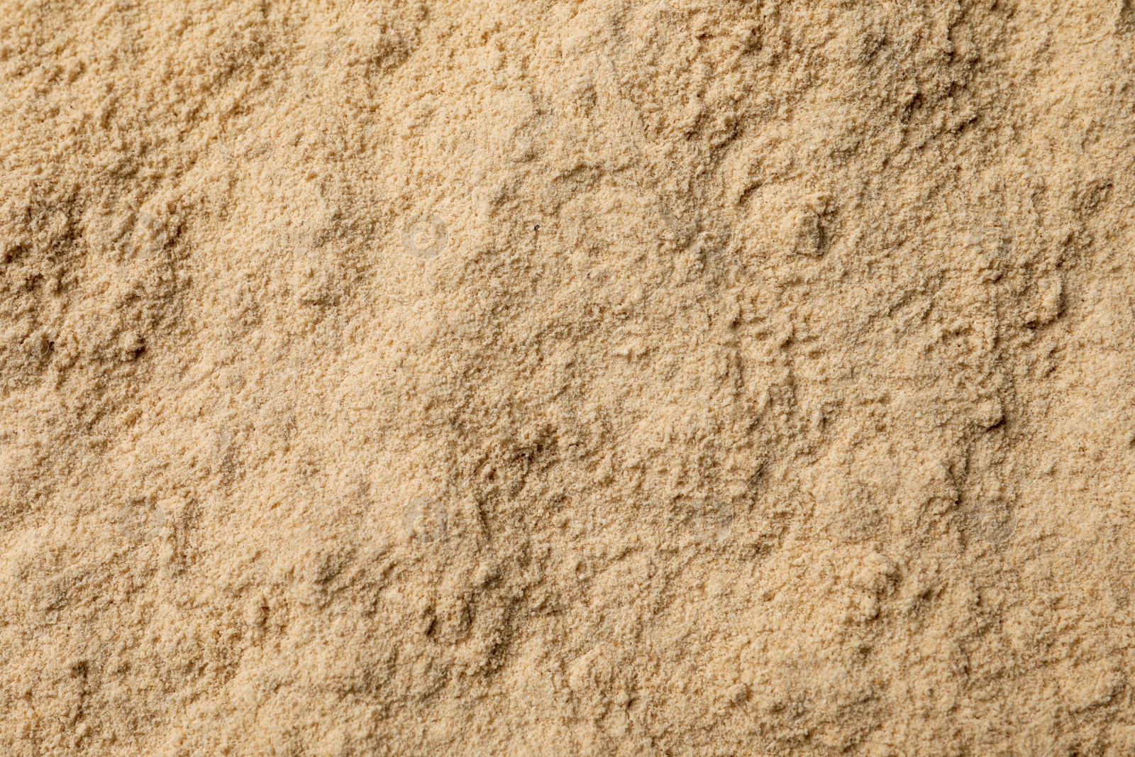 Photo of Heap of buckwheat flour as background, top view