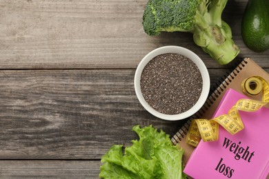 Photo of Flat lay composition with chia seeds, notebooks and measuring tape on wooden table, space for text. Weight loss concept