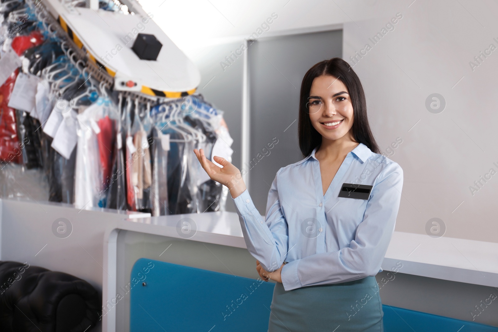 Photo of Female worker near counter at modern dry-cleaner's