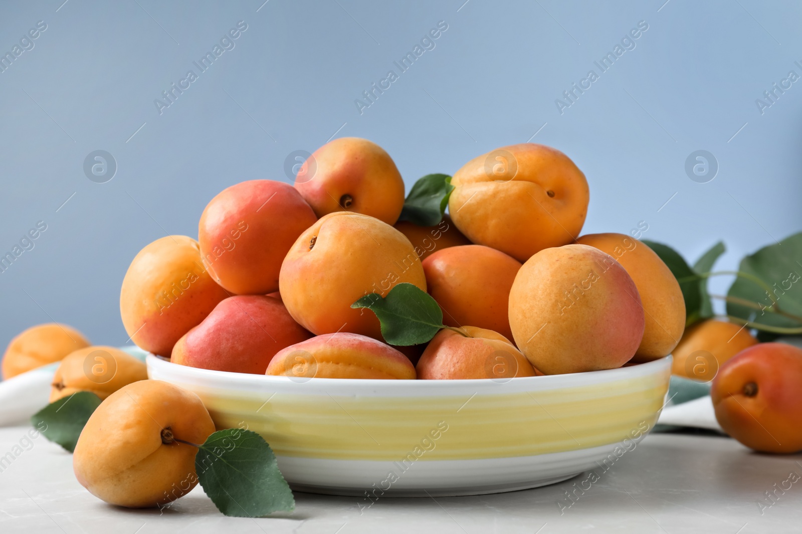 Photo of Delicious fresh ripe apricots on white table