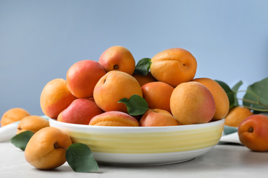 Delicious fresh ripe apricots on white table