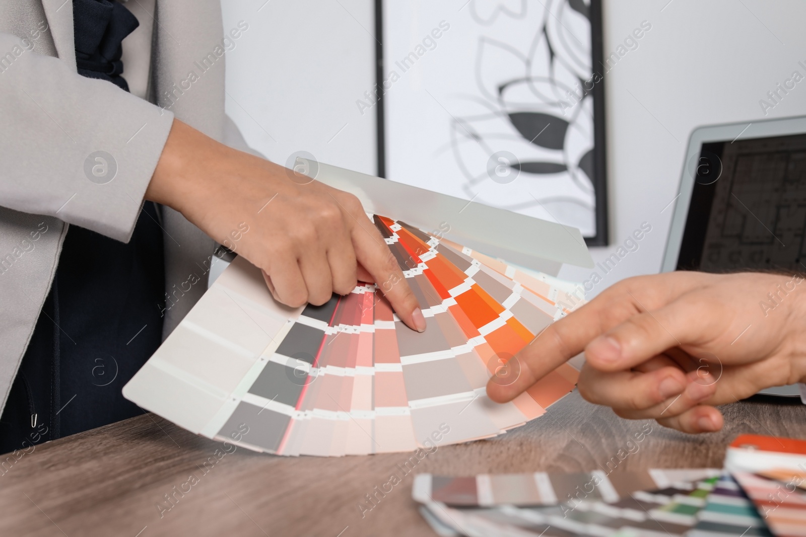 Photo of Team of designers working with color palette at office table, closeup