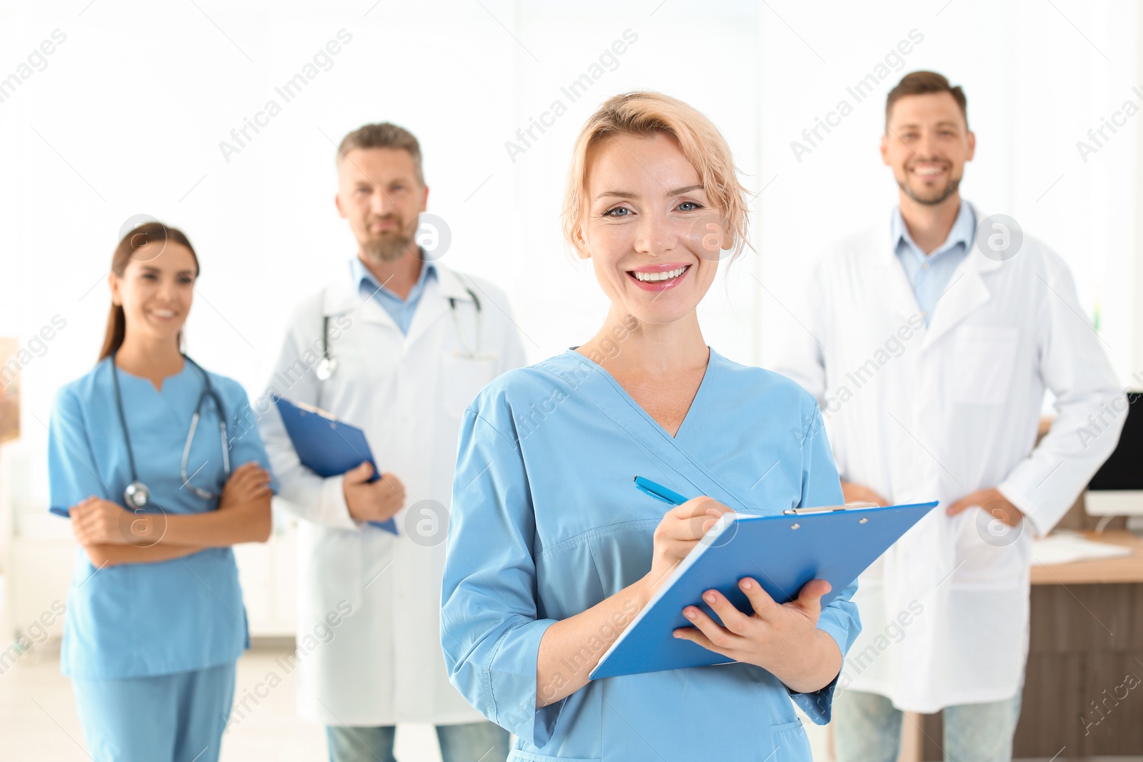 Photo of Medical assistant with colleagues in clinic. Health care service