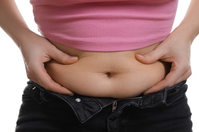 Photo of Woman touching belly fat on white background, closeup. Overweight problem