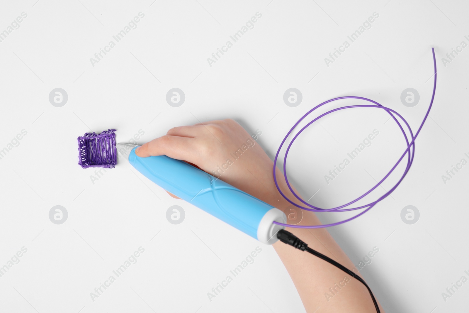 Photo of Boy drawing with stylish 3D pen on white background, top view