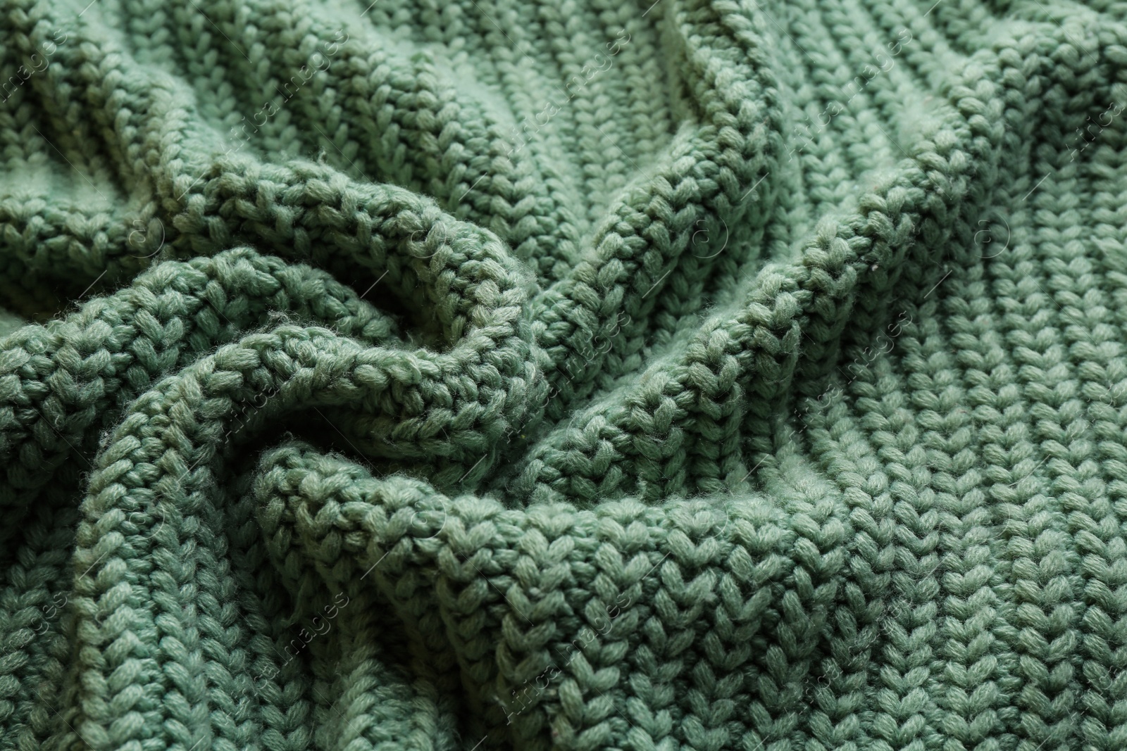 Photo of Beautiful pale green knitted fabric as background, closeup