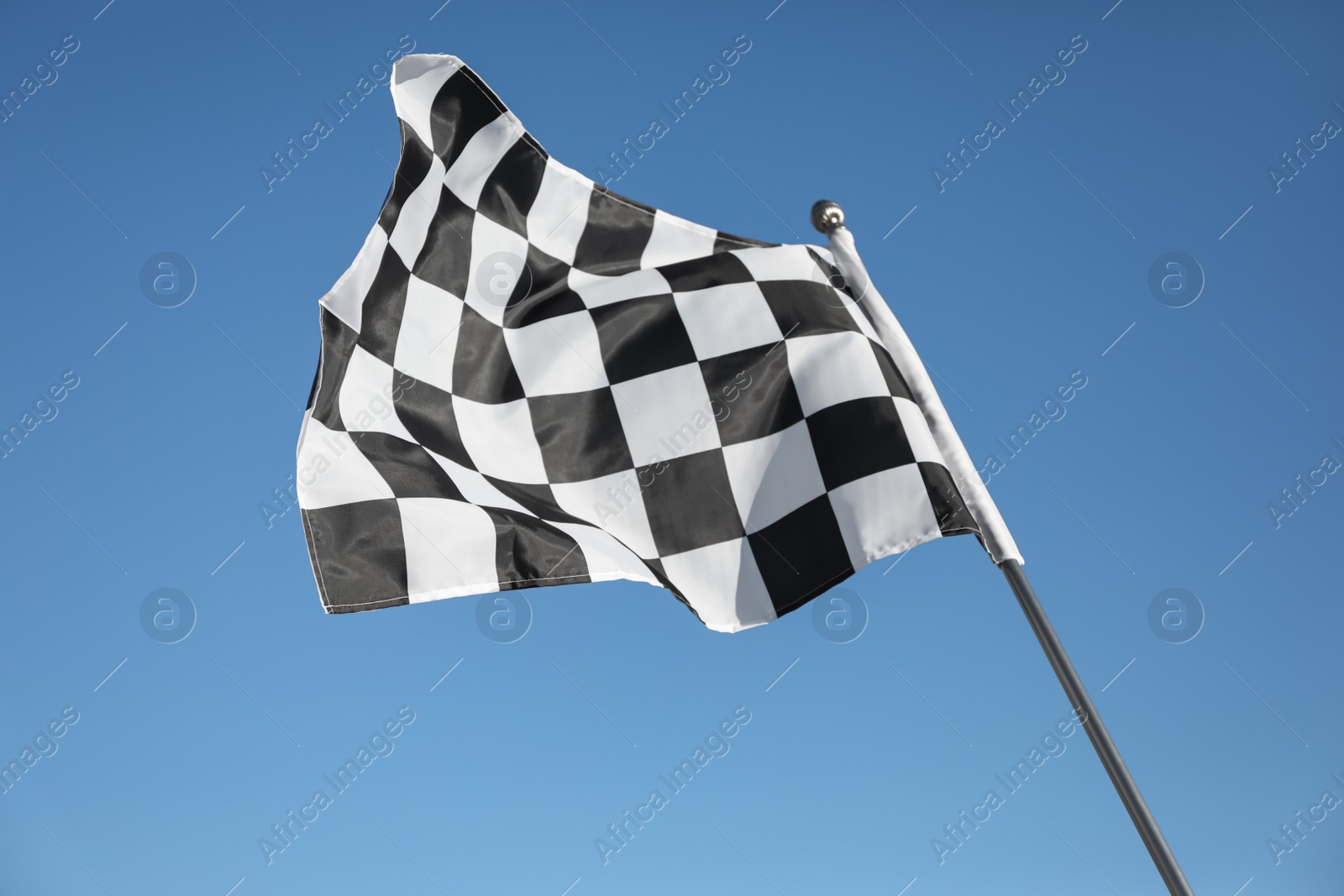 Photo of Checkered finish flag on light blue background