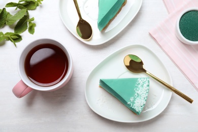 Flat lay composition with tasty spirulina cheesecake on grey table