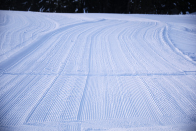 Photo of Empty road covered with snow on winter day