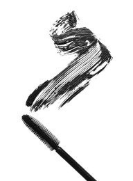 Photo of Smear of mascara and applicator isolated on white, top view