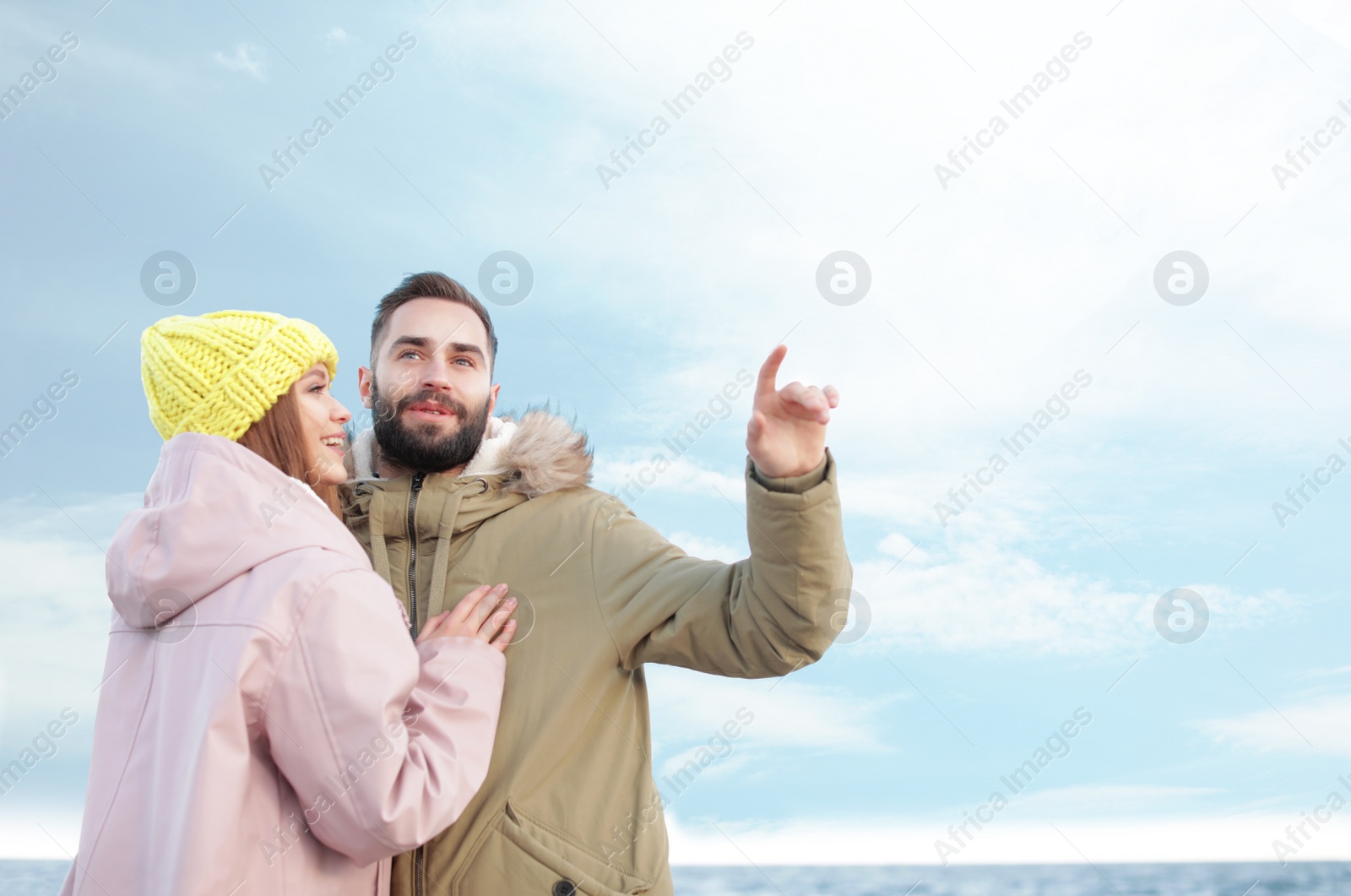 Photo of Lovely young couple spending time near sea