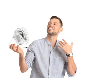 Man refreshing from heat in front of small fan on white background