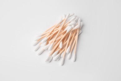 Photo of Pile of clean cotton buds isolated on white, top view