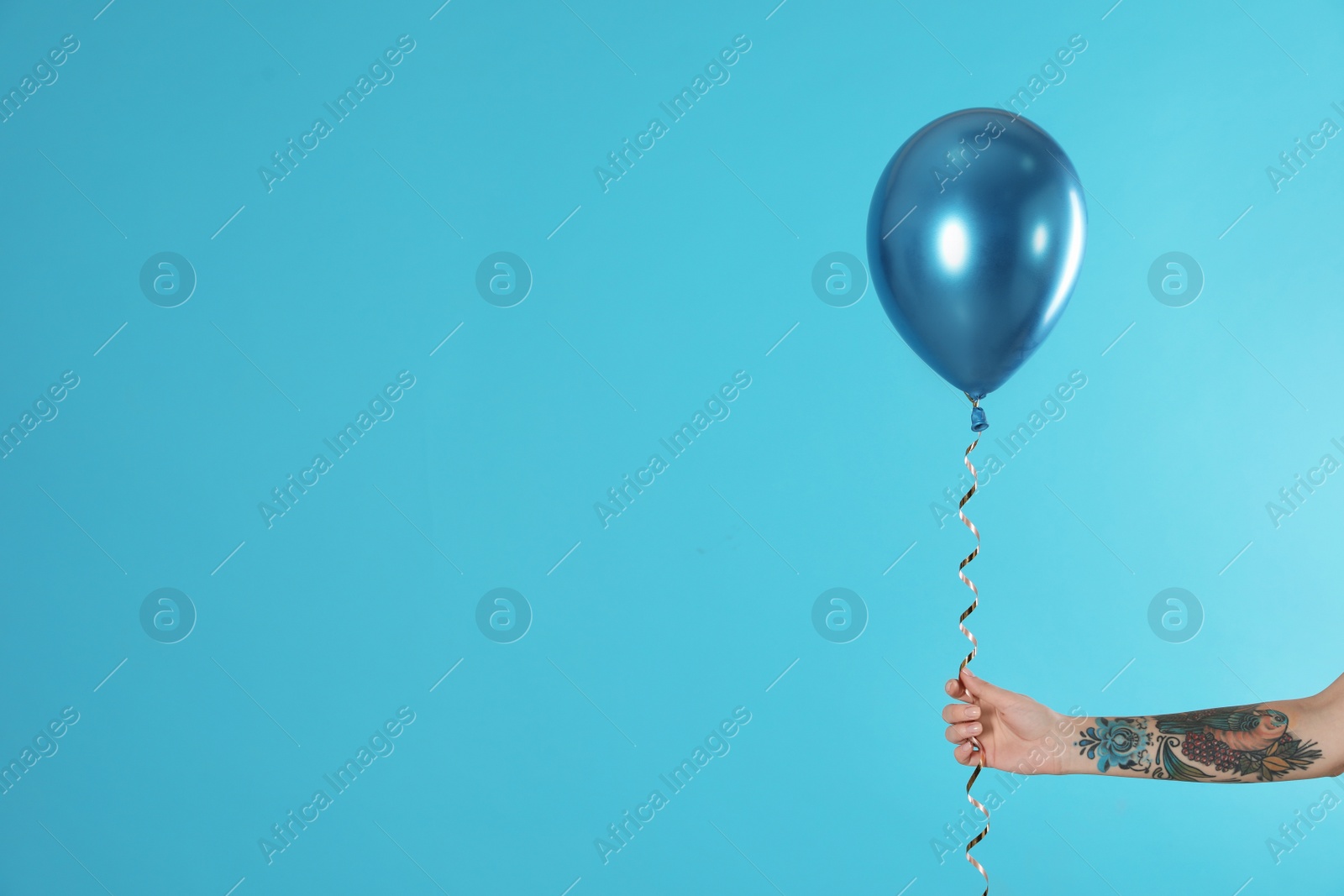 Photo of Woman holding balloon on color background, closeup. Space for text