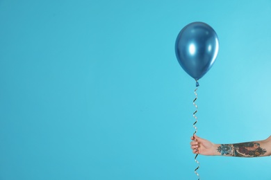 Woman holding balloon on color background, closeup. Space for text