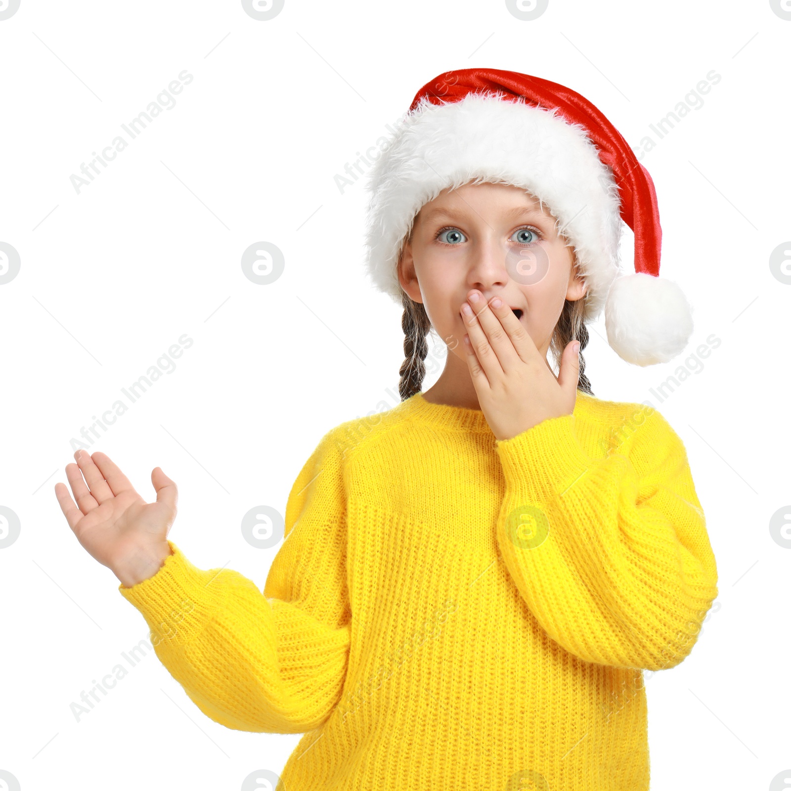 Photo of Emotional little child in Santa hat on white background. Christmas celebration