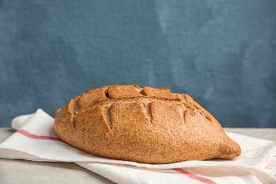 Photo of Fresh bread on table against color background. Space for text