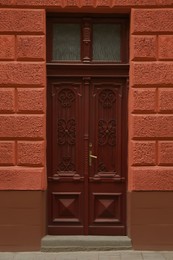 View of building with wooden door. Exterior design