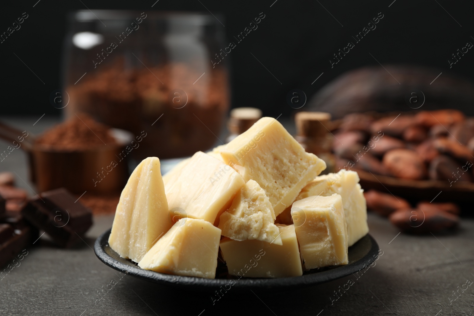 Photo of Organic cocoa butter in plate on grey table