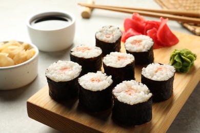 Photo of Tasty sushi rolls served on grey table, closeup