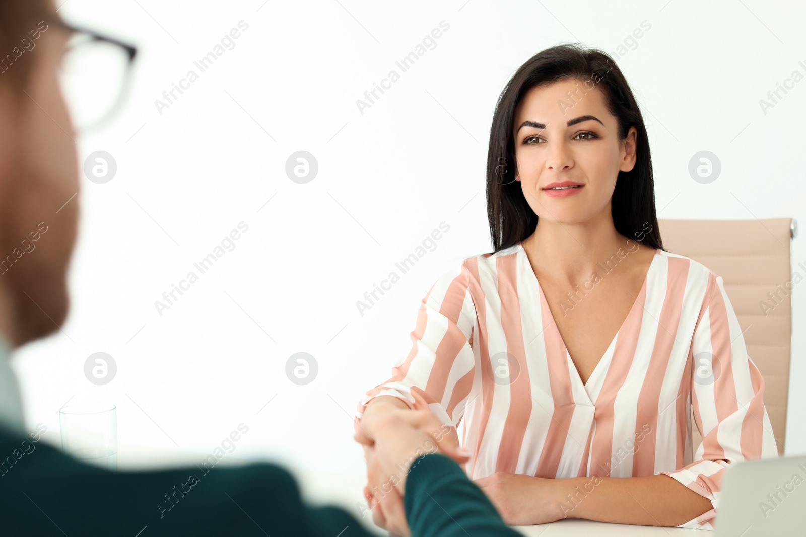 Photo of Human resources manager shaking hands with applicant during job interview in office. Space for text