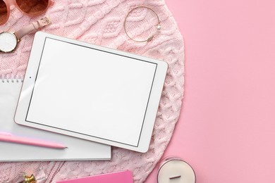 Flat lay composition with modern tablet on pink background. Space for text