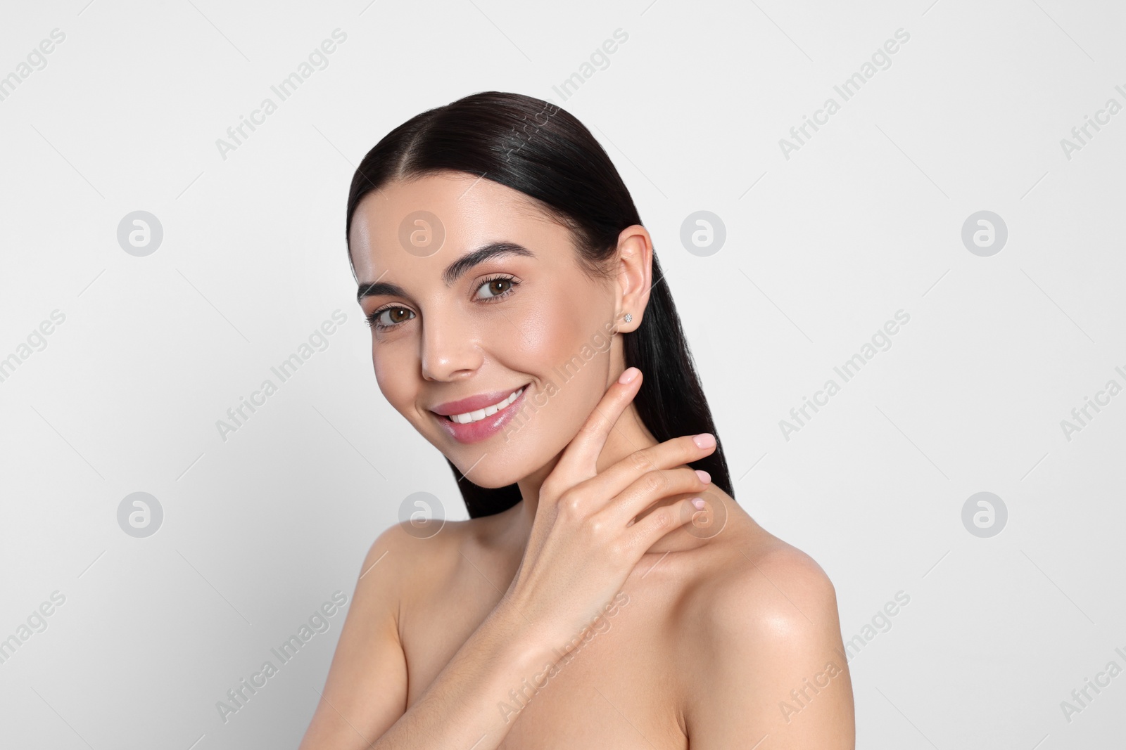 Photo of Portrait of attractive young woman on light grey background. Spa treatment