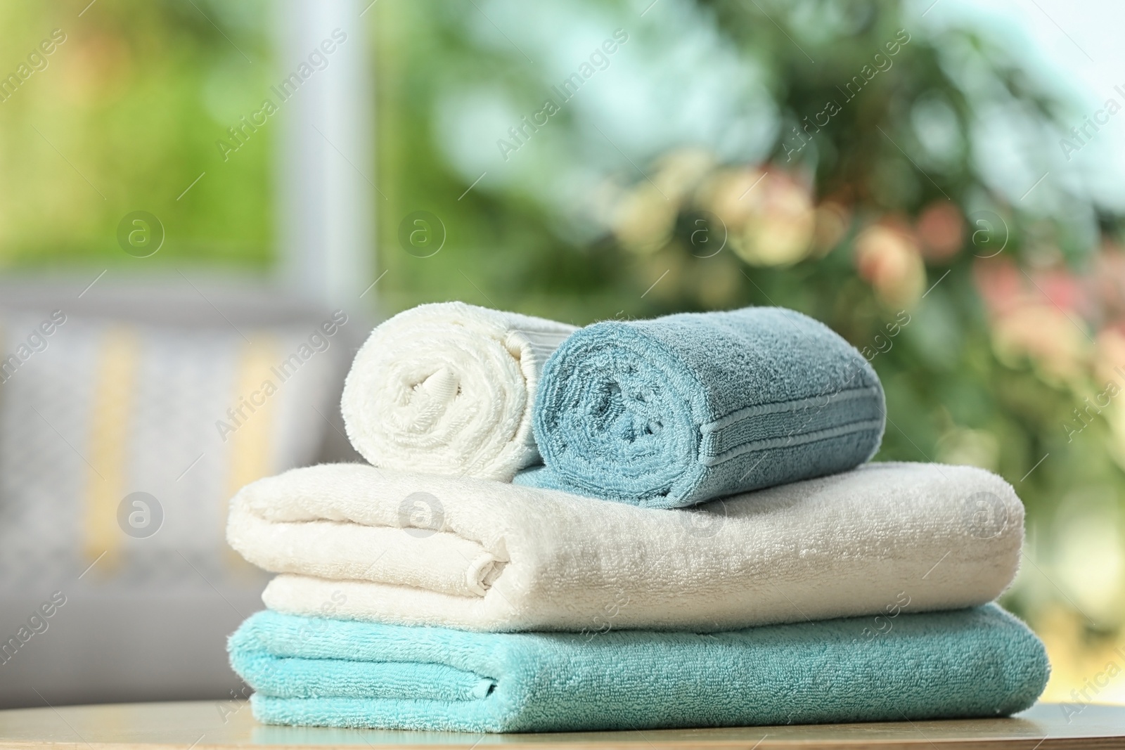 Photo of Clean soft terry towels on table indoors