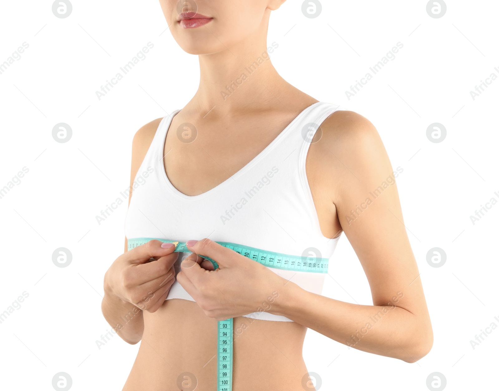 Photo of Young woman measuring breast size on white background, closeup. Cosmetic surgery