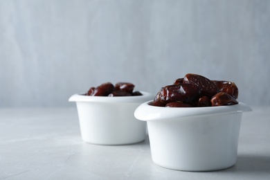 Photo of Bowl with sweet dates on table, space for text. Dried fruit as healthy snack