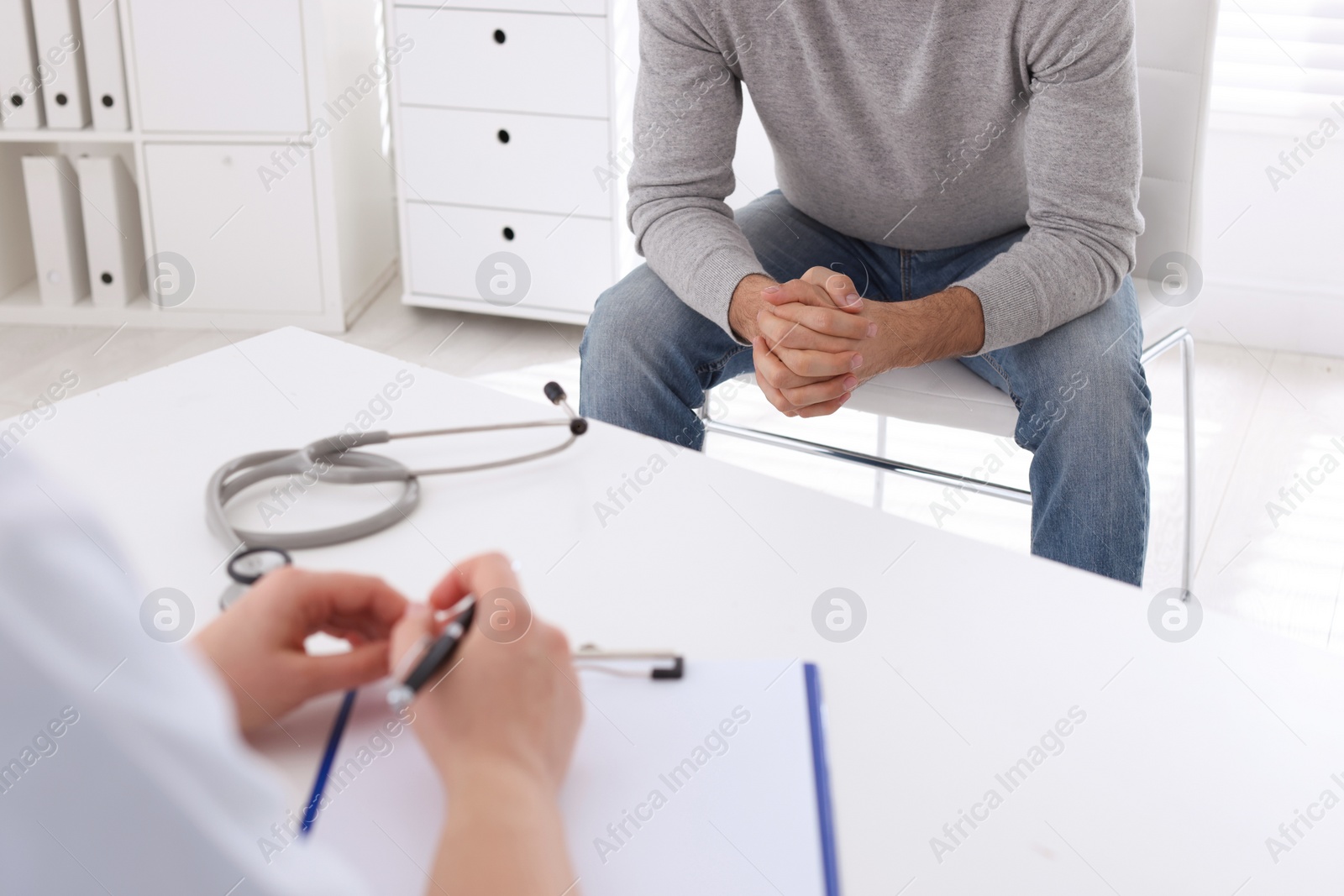 Photo of Man having appointment with STD specialist in clinic, closeup