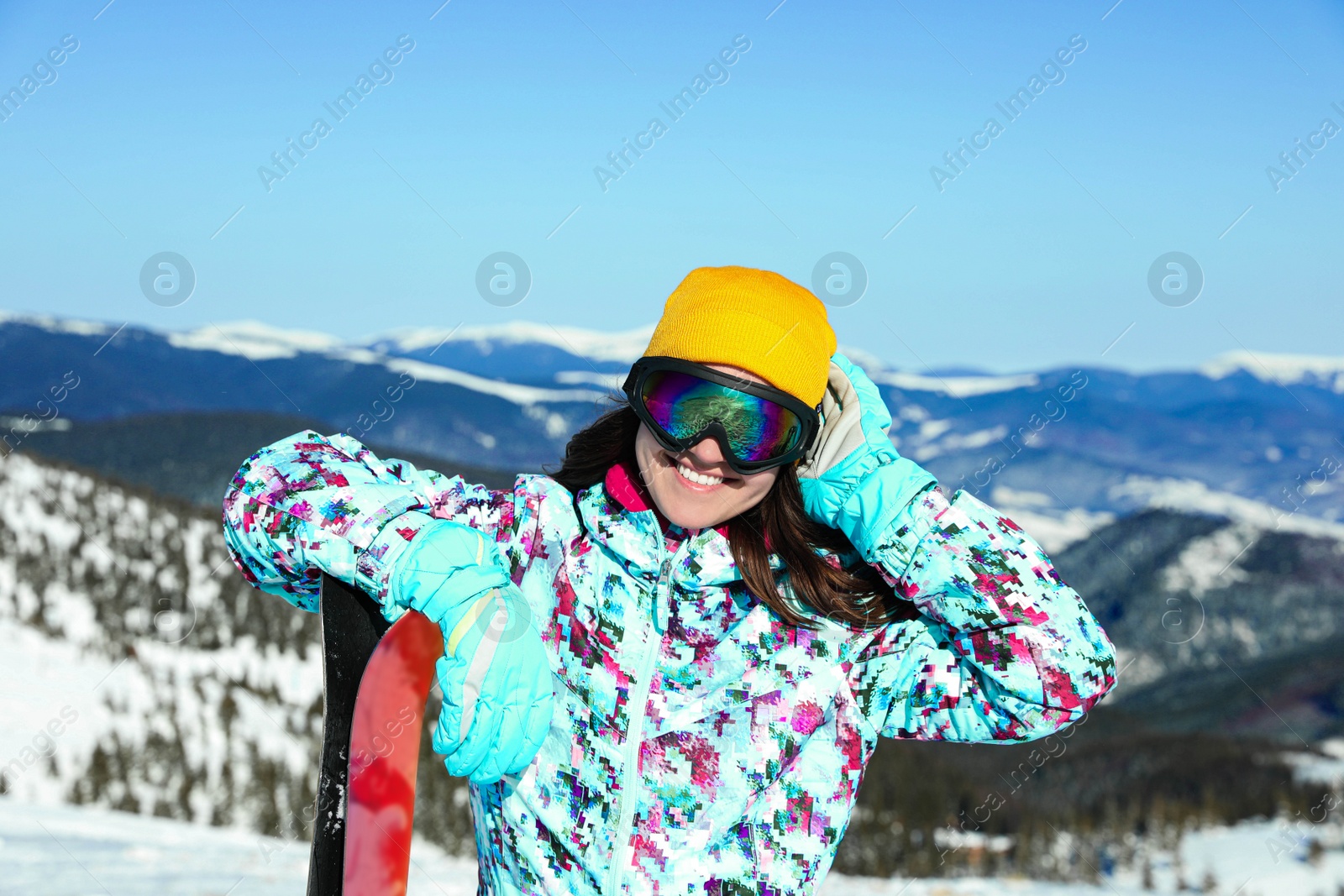 Photo of Young woman with ski equipment in mountains. Winter vacation